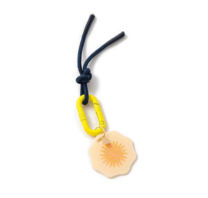 bright yellow and navy blue keychain with sun design