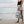 model holding the nixon backpack on the beach 