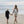 model walking with a child on beach with oh coconuts backpack