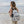 Model walking along little cove beach with backpack 