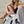 Model sitting on the beach with coco beach bag open and born in noosa heads showing inside of beach bag