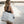 model holding coco beach bag at sunset at little cove beach