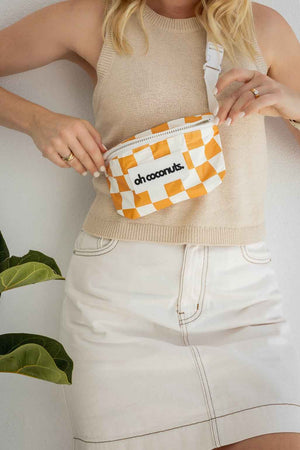 white and mustard bumbag on model 