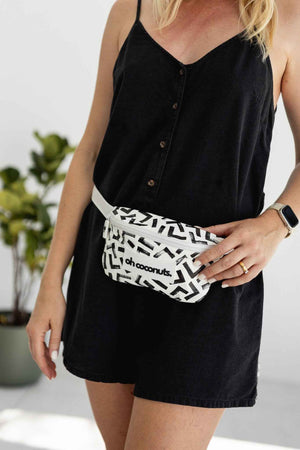 Black and white bumbag on model in black dress