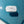 blue and white cosmetic bag floating in pool. 