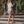 Model walking up stairs with crossbody bag