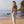 Model walking on little cove beach with crossbody bag