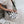 black and cream crossbody bag with black strap on model in linen dress