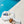 blue gym duffel bag with matching cosmetic bag sitting by a pool with a coconut