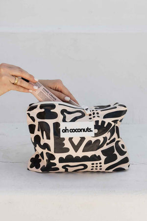 model holding black and beige oh coconuts bag