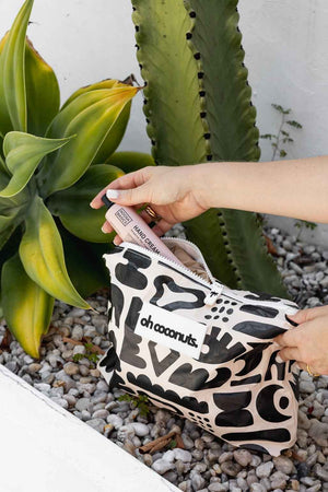 cactus background with black and beige wet dry bag with model
