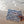 hand holding blue wet dry pouch on beach 