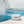 water splashing from pool onto white and blue checkered bag